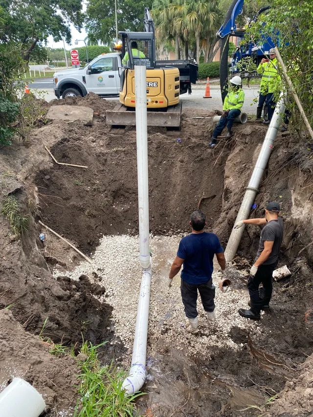 Tier One crew repairing a sewer line in a residential yard